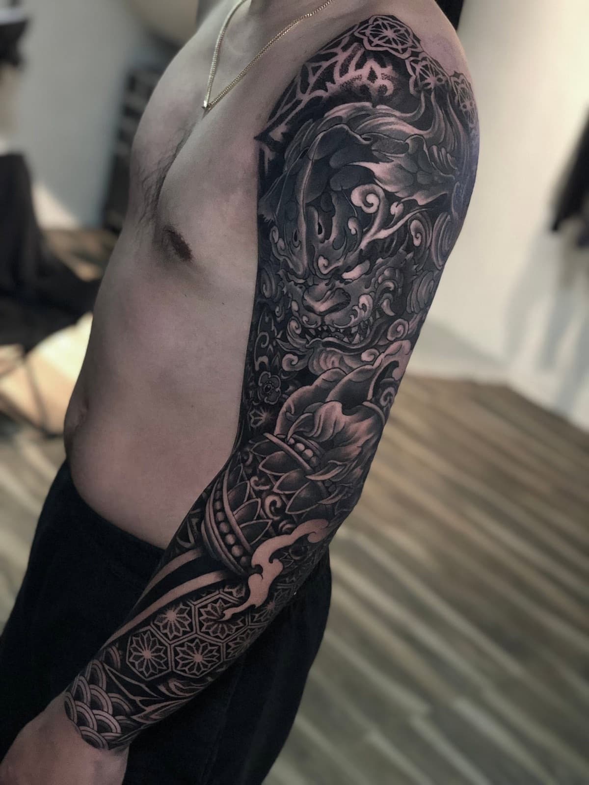 blackwork guardian lion and all-seeing eye full sleeve tattoo by park nichole lladoc — gorillaz tattoo art studio philippines