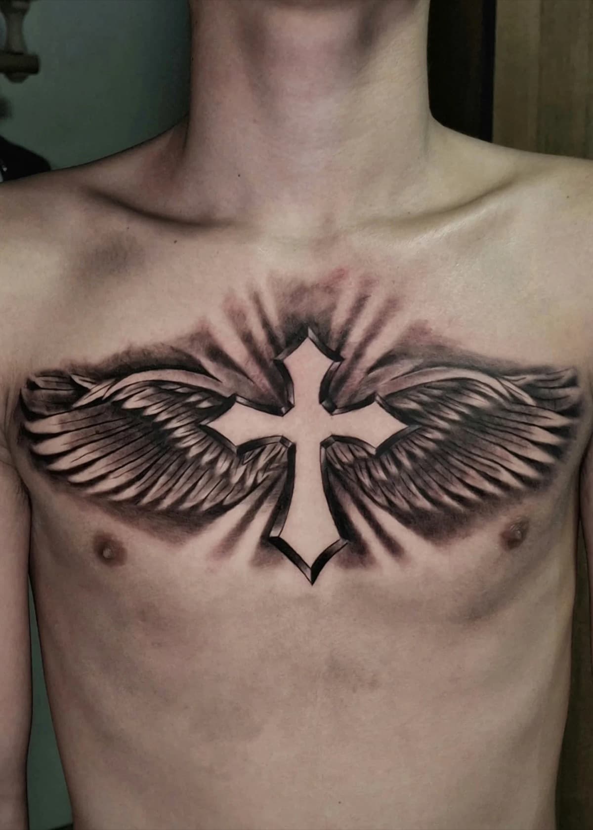 blackwork winged cross chest tattoo by isaiah recongco — gorillaz tattoo art studio philippines