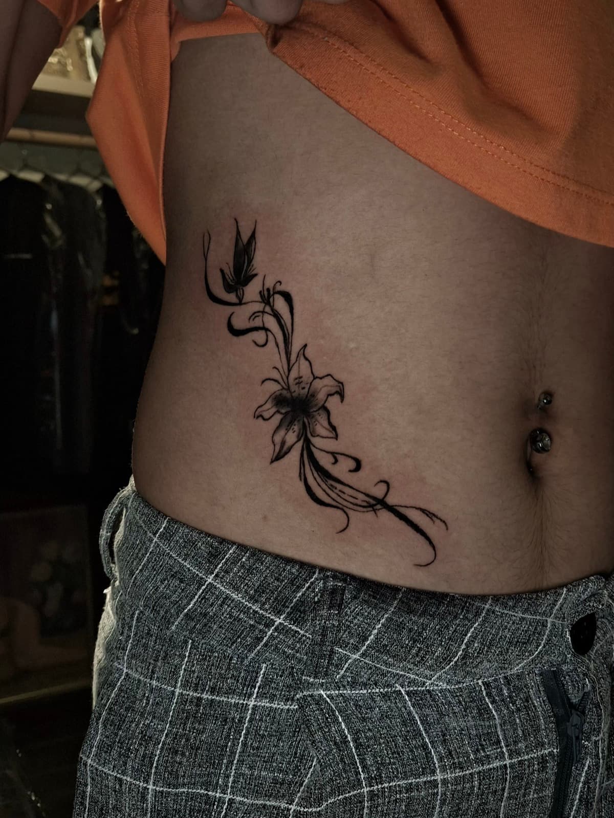 fine line lily flower rib tattoo by isaiah recongco — gorillaz tattoo art studio philippines