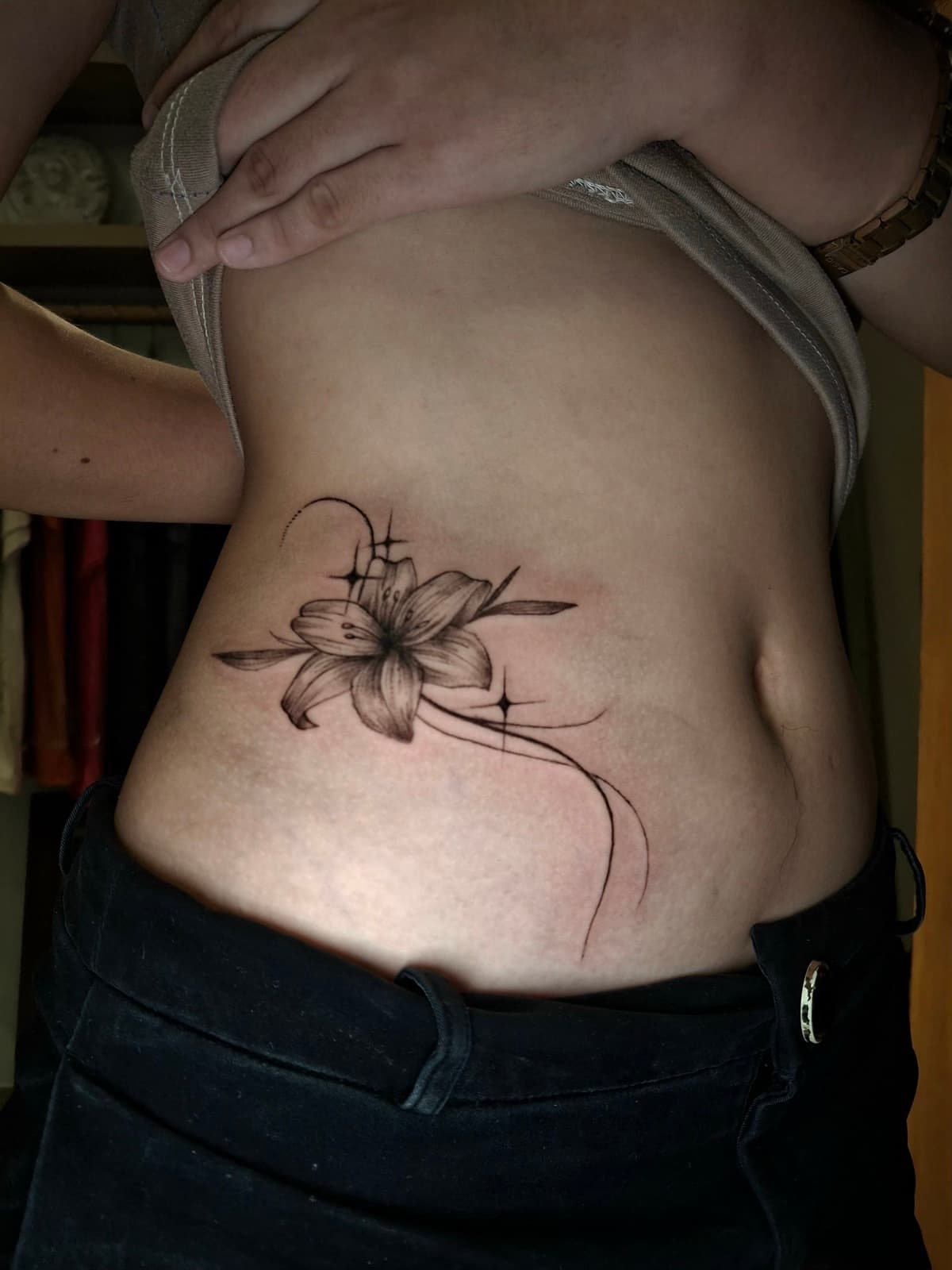 fine line lily flower and stars ribcage tattoo by isaiah recongco — gorillaz tattoo art studio philippines